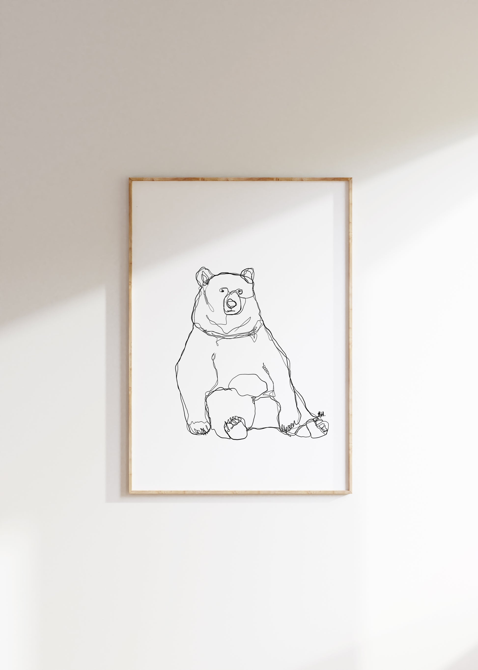 Sitting bear one line drawing, black and white art print framed in a wood frame